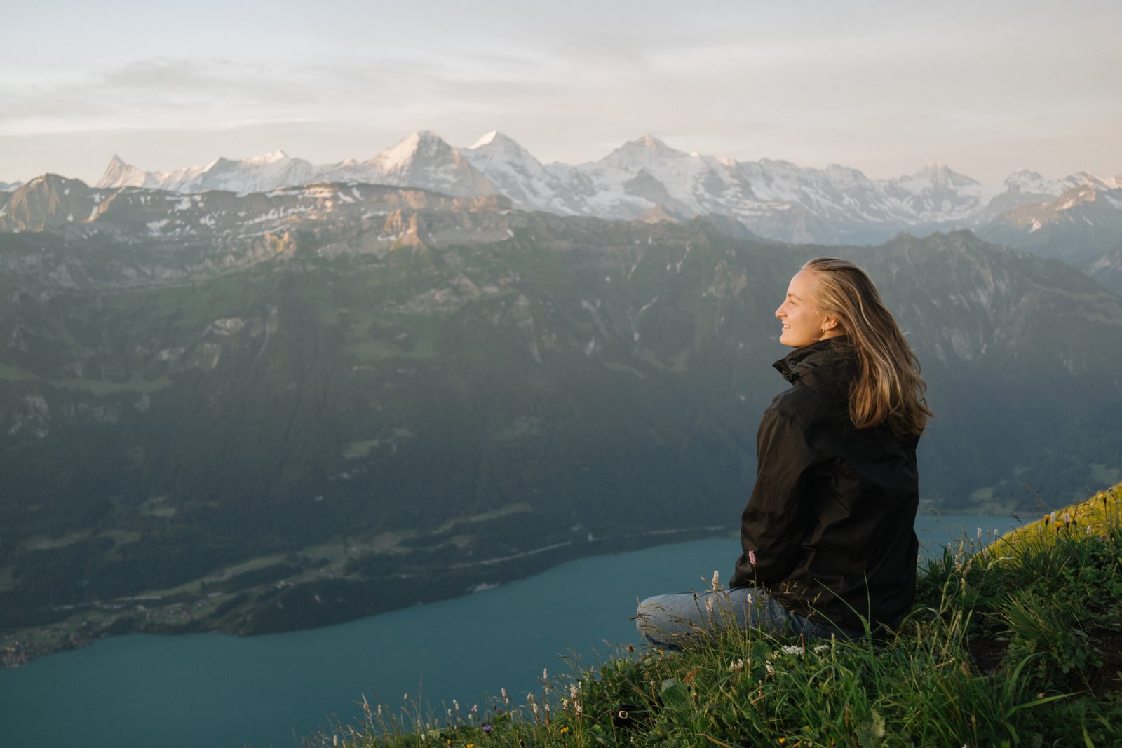 She looks off to the distant European Alps over lake Lugano