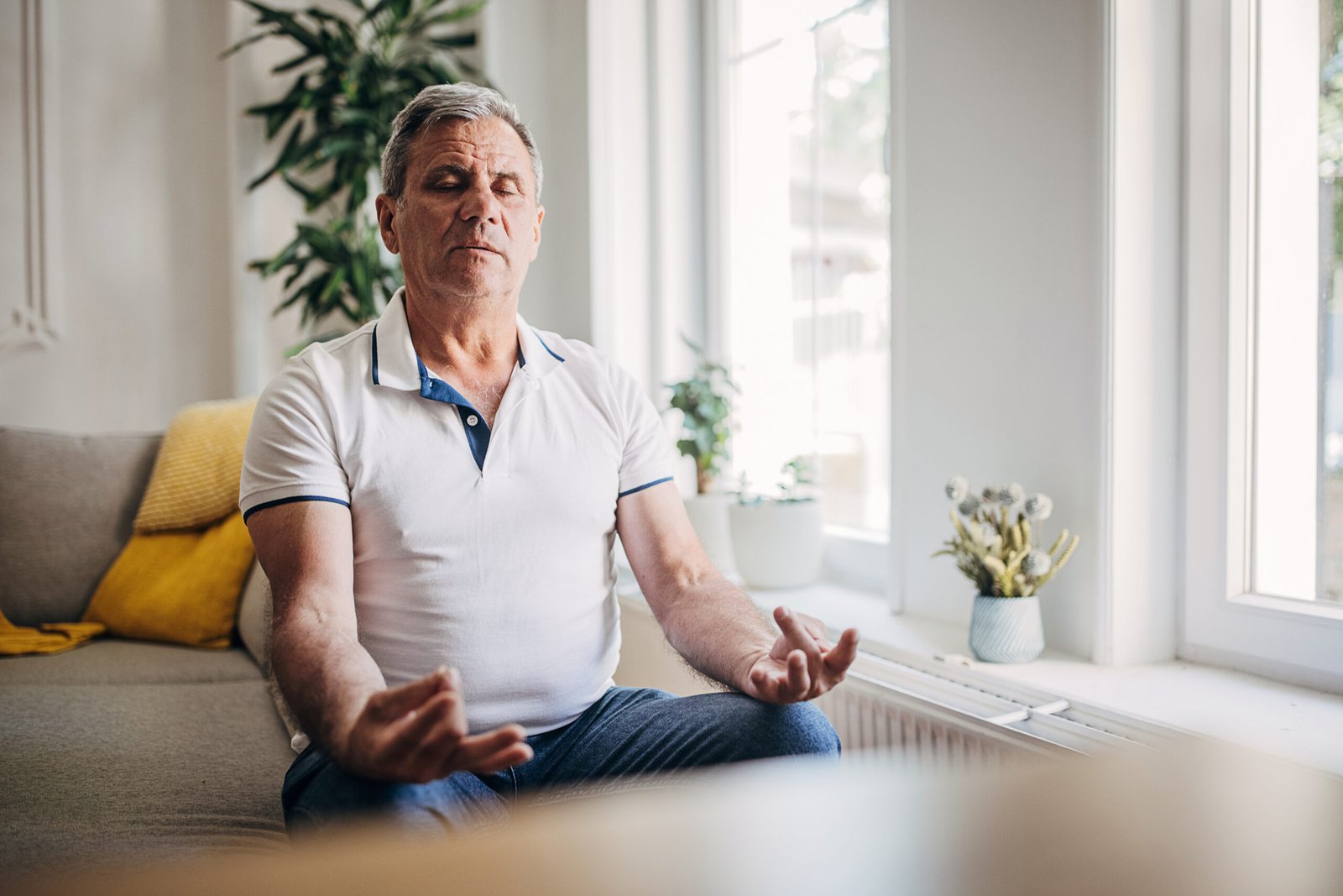 The older man relaxes, does yoga